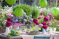 Table with Paeonia - peony and lanterns, 