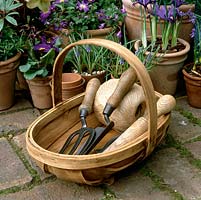 Wooden trug with string, bulb planter, trowel and fork.