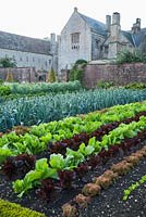 Kitchen garden with colourful rows of lettuces and leeks. Forde Abbey, nr Chard, Dorset, UK