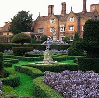 Formal, early C20 knot garden. Statues, yew topiary - peacocks, chess pieces and abstract shapes. Low box hedges mark parterre pattern. Tudor brick mansion.