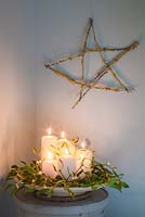 A festive star made from Prunus with Lichen cuttings, accompanied with Candles and Mistletoe. 