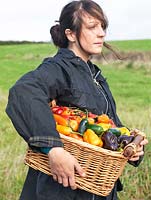 Josie Alice Kirby carries a basket of mixed chilli peppers.