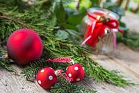 Red polkadot baubles with cedar and yew foliage