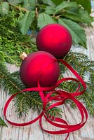 Red baubles with Ribbon, cedar and yew foliage