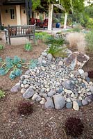 Pebble feature in dry garden