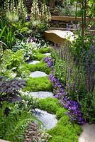 Stepping stone path leading to wooden bench with letters carved into stone by Martin Cook - RHS Chelsea Flower Show 2011