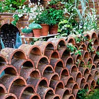 A low garden wall created from reclaimed terracotta ridge tiles.