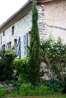 Rose clad stone cottage.  Part of the property and garden at Domaine de Chatelus de Vialar.  
