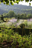 Part of the potager with formal flowerbeds behind at Domaine de Chatelus de Vialar