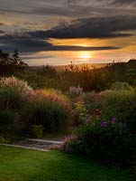 The Anniversary Grass Garden at dawn, planted with Miscanthus, Deschampsia, Cortaderia and Stipa.