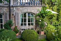 Box topiary around house and patio. Marina Wust, Germany