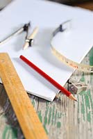 Tools for garden surveying and planning. Ruler, graph paper, pencil, compass and tape measure
