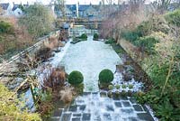 Formal town garden with snow