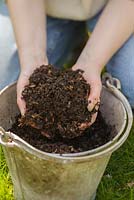 Woman holding home made garden compost