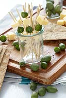 Baby kiwi fruits and cheese cubes on cocktail sticks - Actinidia arguta 'Issai'