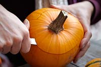 Carving pumpkin with knife 