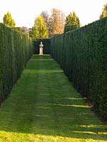 Formal yew allee, its focus a statue of Byron, seen as the sun sinks.