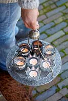 Woman holding tray with candles
