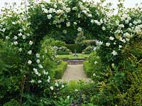 Rose Garden framed by moongate of Rosa City of York. Lily pond with sculpture. Box-edged beds of roses - Comte de Chambord, Prosperity, andersonii, Felicia.