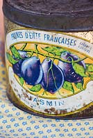 Old antique rusty tin of traditionally made french prunes.
