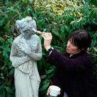 Live yoghurt is being painted onto a new reproduction statue, cast in concrete, to encourage lichen growth.