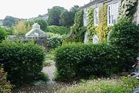 View across the Vean Garden to the conservatory and Truro beyond. Bosvigo, Truro, Cornwall, UK