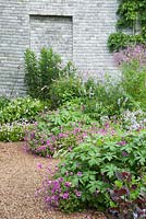 The Walled Garden planted with purples, pinks and blues including Geranium Patricia - 'Brempat', galega, thalictrums, campanula and violas. Bosvigo, Truro, Cornwall, UK