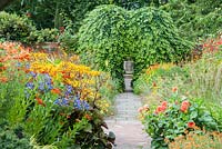 Lanhydrock Garden, otherwise known as the hot garden, planted with heleniums, dahlias, Ligularia dentata 'Desdemona', Erysimum 'Apricot Twist' and agapanthus. Wollerton Old Hall, nr Market Drayton, Shropshire, UK