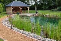 Swimming pond and covered seating area. July.