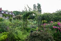 View of Snape Cottage Garden with Rosa 'American Pillar'