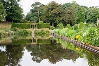 The Long Pond and Border at Forde Abbey in early Summer with view to Ionic Temple.