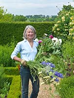 Susie Pasley-Tyler collects peonies, delphiniums, astrantia and Cephalarea gigantea for a flower arrangement in the house.