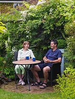 Anne and John Massey sitting in their 16 metre square back garden 