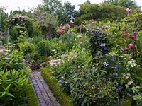 Box parterre with brick paths and herbaceous borders including roses 'Charles de Mills', 'Mme Isaac Pereire' and Clematis 'Prince Charles'.