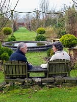 Mark and Jackie Porter sit overlooking their formal rose garden