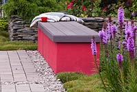 Geometrical bench in modern style garden with Liatris spicata 