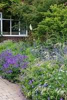 The front garden is filled with hardy geraniums, catmint, foxgloves, nigella, grasses and vegetables.
