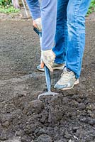 Lawn Restoration. After removing the top 3 - 4cm of the old lawn, the soil is dug to a depth of 15cm.