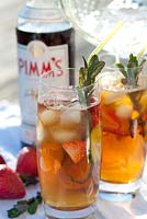 Glasses of Pimm's with mint, strawberry and cucumber