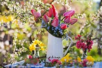 Floral arrangements of tulips, forget-me-nots, daffodils and Japanese quince.