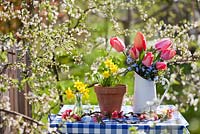 Floral arrangements of tulips, forget-me-nots and daffodils.