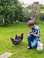 Sebastian feeding the chickens Victoria Peckham, Omlette, Cluck Norris and Vindaloo.