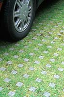 Concrete block and grass pavers in car park 