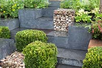 Ooooh ...it makes me wonder. Malvern Spring Gardening Show 2014, inspired by the classic Led Zeppelin song 'Stairway to Heaven', and the Giant's Causeway rock formation, with squares of buxus, gabions and planting - Designer: Teresa Rham - Sponsor: The Dingle Nurseries and Gardens