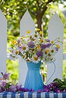 Summer floral arrangements of wildflowers - buttercups, daisies, honesty, field scabious