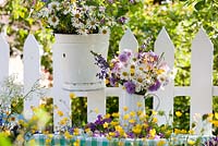 Summer floral arrangements of wildflowers - buttercups, daisies, honesty, field scabious, meadow clary, columbine, meadow cranesbill