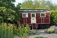 A vintage caravan serves as an unusual summerhouse