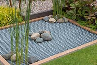 Water storage pond covered with grate and decorative stones