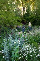 The M and G Garden - The Retreat. View of flowerbed with Artemisia absinthium 'Lambrook Silver', Lysimachia atropurpurea 'Beaujolais', Centranthus ruber 'Albus' 