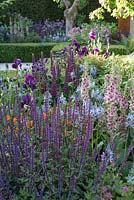 The Morgan Stanley Healthy Cities Garden, mixed purple, blue and orange planting with Lupins, Camassia quamash, Verbascum, Irises, Salvia and orange poppies. 
